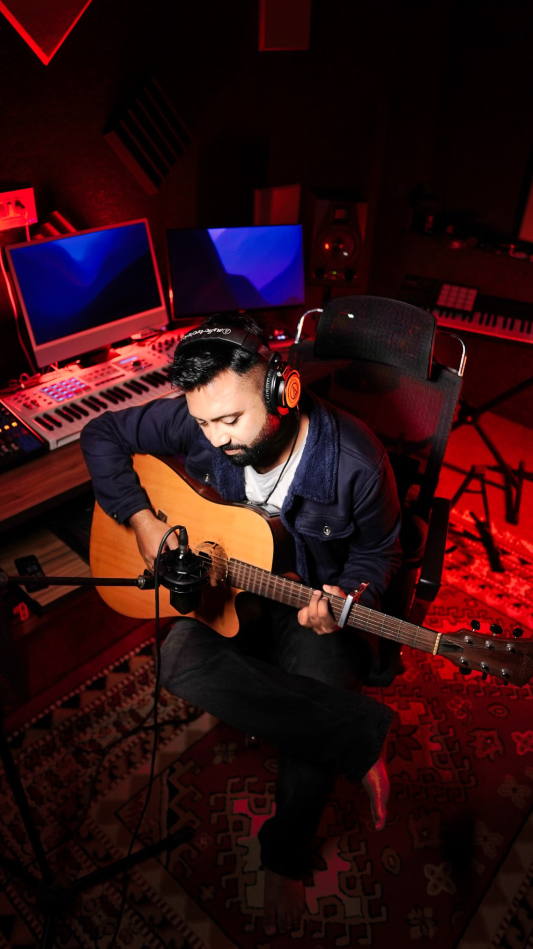Arijit Saha recording acoustic guitar in his studio